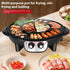 Electric grill and hot pot combo with assorted meats, seafood, and vegetables cooking, indoor kitchen setting.