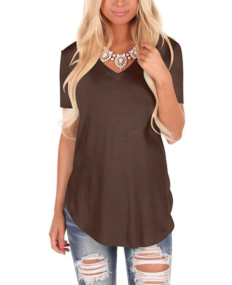 Woman wearing loose brown V-neck short sleeve top with ripped blue jeans
