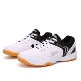 White and black low-top sneakers with gum sole, mesh accents, and sporty laced design.