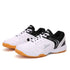 White and black low-top sneakers with gum sole, mesh accents, and sporty laced design.
