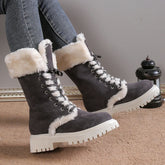 Gray suede winter boots with white faux fur lining and chunky lug soles, worn with jeans.