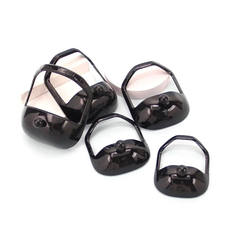 Set of black glossy plastic bag handles with simple modern design on white background