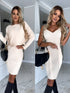 Woman wearing a beige ribbed knit bodycon dress with long sleeves or sleeveless options, paired with black knee-high boots and a black handbag, in a modern indoor setting.