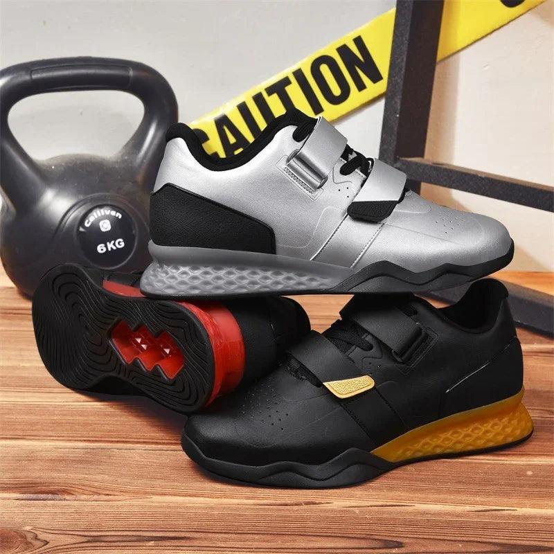 Two pairs of athletic sneakers, one silver and black, one black and yellow, with mesh and leather material, lace-up and strap closure, displayed on a wooden floor near a kettlebell and caution tape.