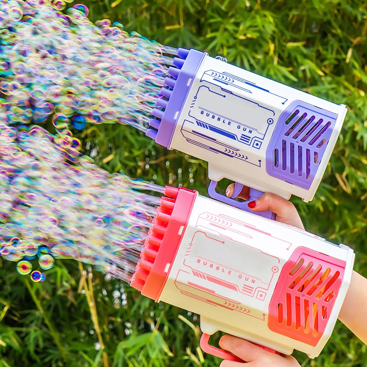 Colorful plastic bubble guns with red and purple accents blowing bubbles outdoors