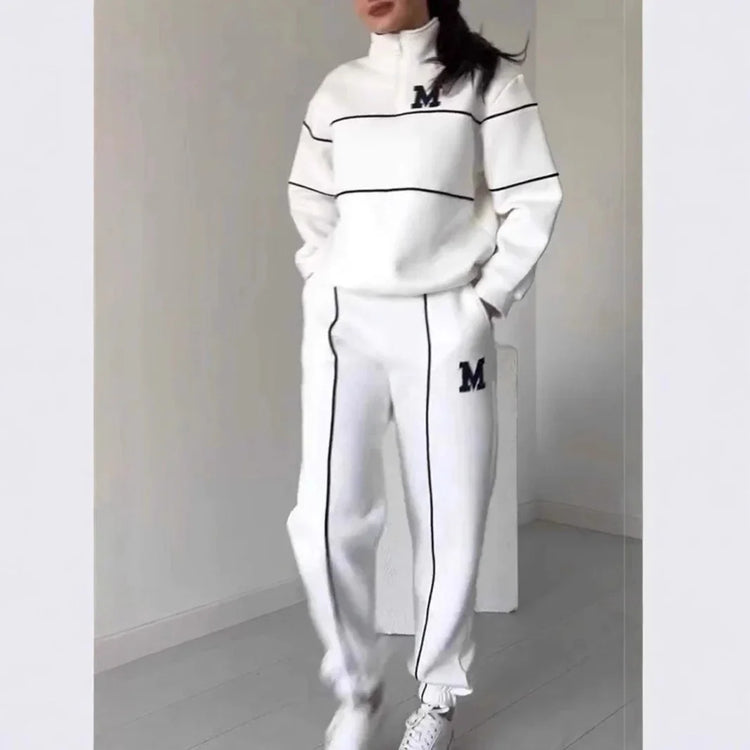 White relaxed-fit tracksuit with black piping, zip collar, and letter M on top and pants