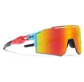 Futuristic streetwear sunglasses with oversized mirrored shield lens, red and blue frame, athletic fit