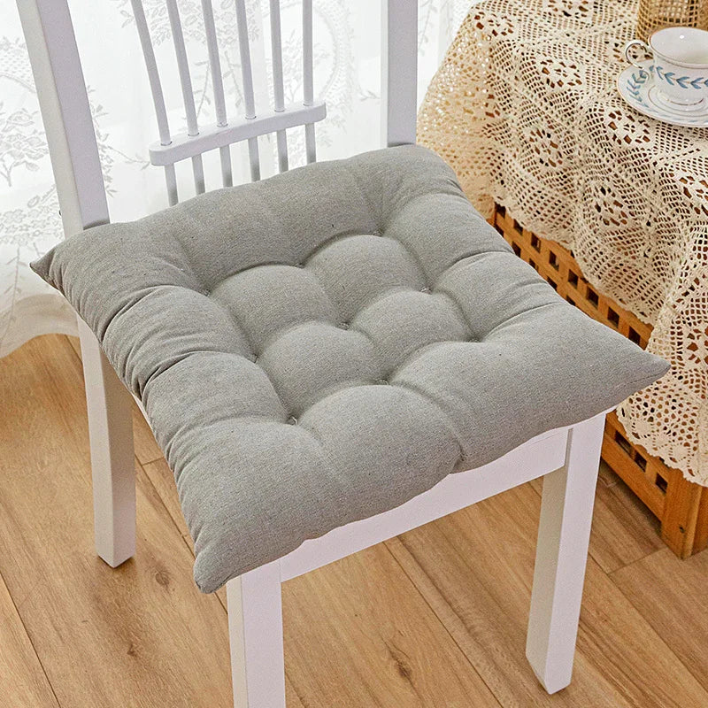 Light grey tufted cushion on white wooden chair, soft cotton seat pad, modern home decor