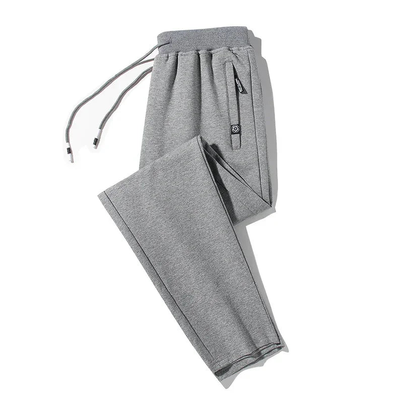 Gray tapered sweatpants with drawstring waist, soft knit fabric, relaxed fit, side pocket detail