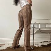 Woman wearing high-waisted brown striped flared pants, fitted casual streetwear style
