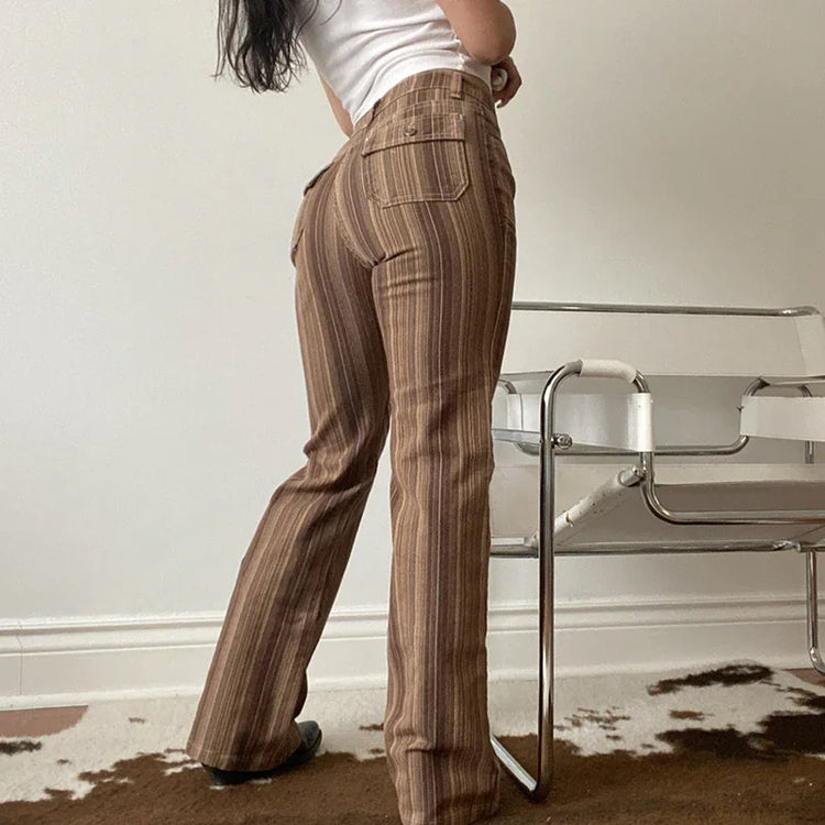 Woman wearing high-waisted brown striped flared pants, fitted casual streetwear style