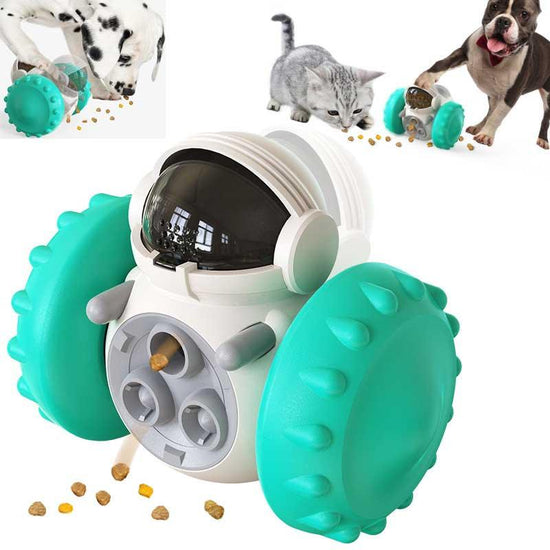 Pet treat dispenser toy with teal textured wheels and astronaut design, shown with dogs and cat