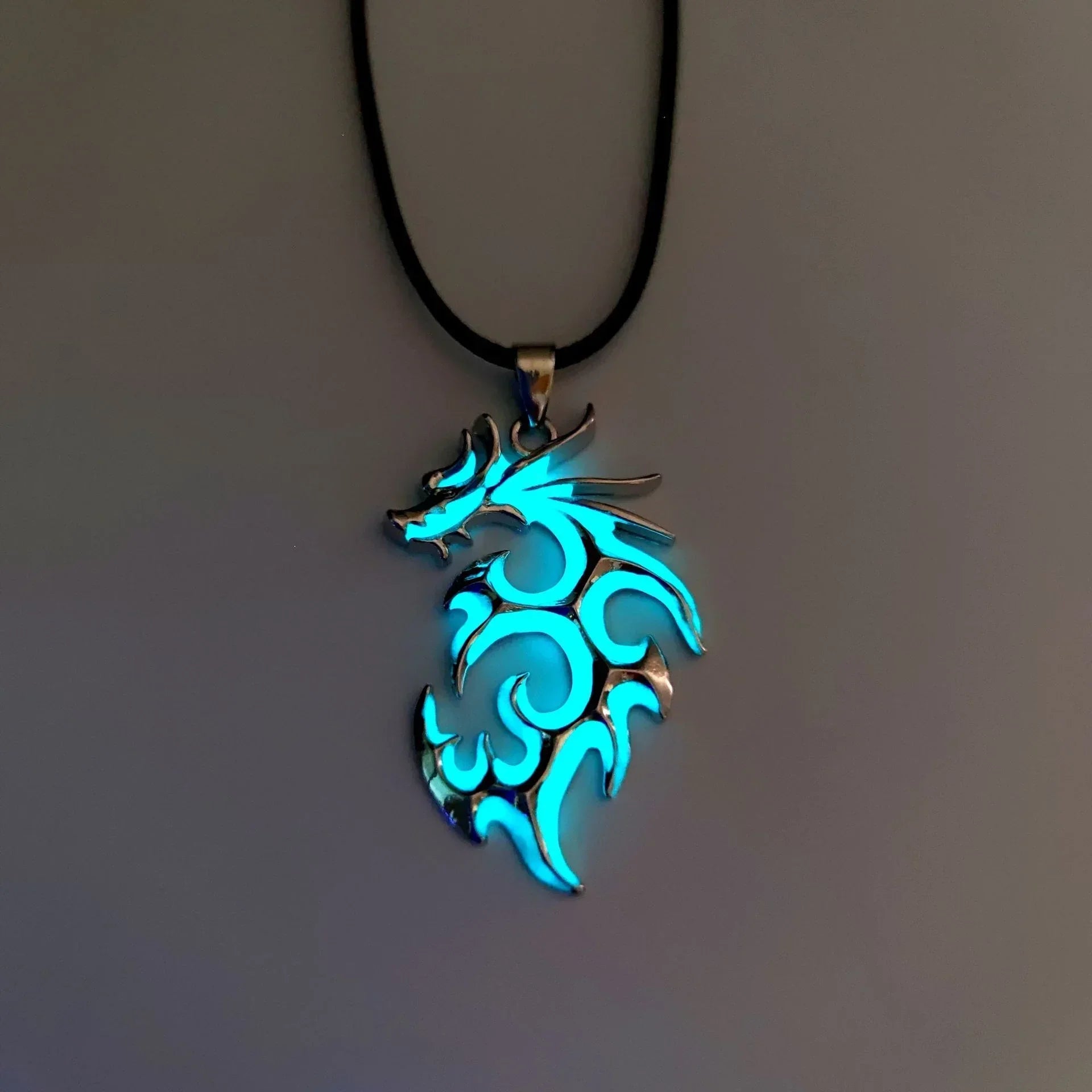 Glowing blue tribal dragon pendant necklace on black cord, metallic finish, streetwear accessory