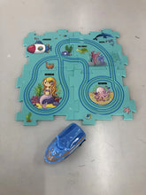Colorful undersea-themed puzzle mat with cartoon mermaid, sea animals, and a blue toy boat.