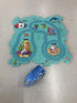 Colorful undersea-themed puzzle mat with cartoon mermaid, sea animals, and a blue toy boat.