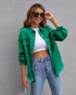Woman in green oversized distressed denim jacket, white crop top, and high-waisted blue jeans