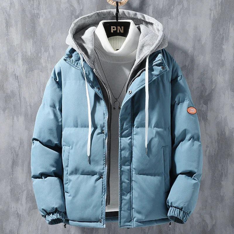 Blue puffer jacket with gray hood, white turtleneck, and relaxed streetwear fit