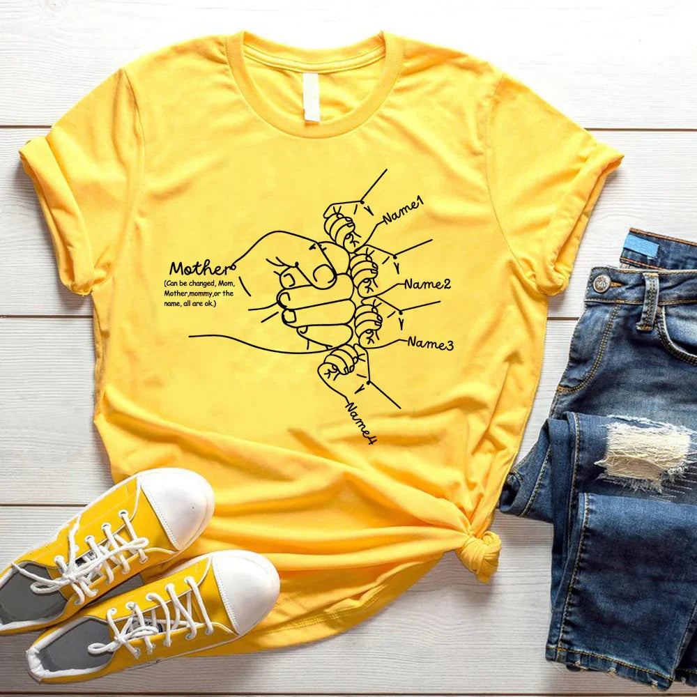 Yellow cotton graphic t-shirt with minimalist line art, paired with denim shorts and sneakers