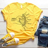 Yellow cotton graphic t-shirt with minimalist line art, paired with denim shorts and sneakers