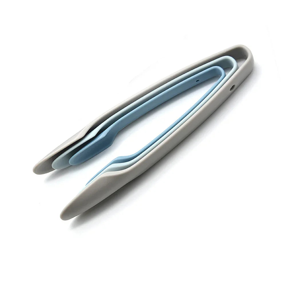 Set of three stackable pastel kitchen tongs in blue and gray plastic, minimalist design