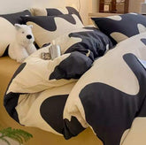 Minimalist black and white gradient color cotton bed set with pillows and duvet on beige mattress