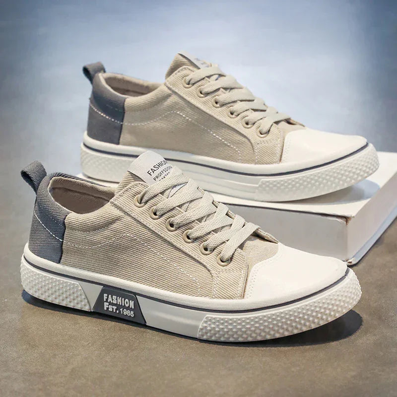Beige canvas low-top sneakers with white rubber soles and gray accents, casual streetwear style