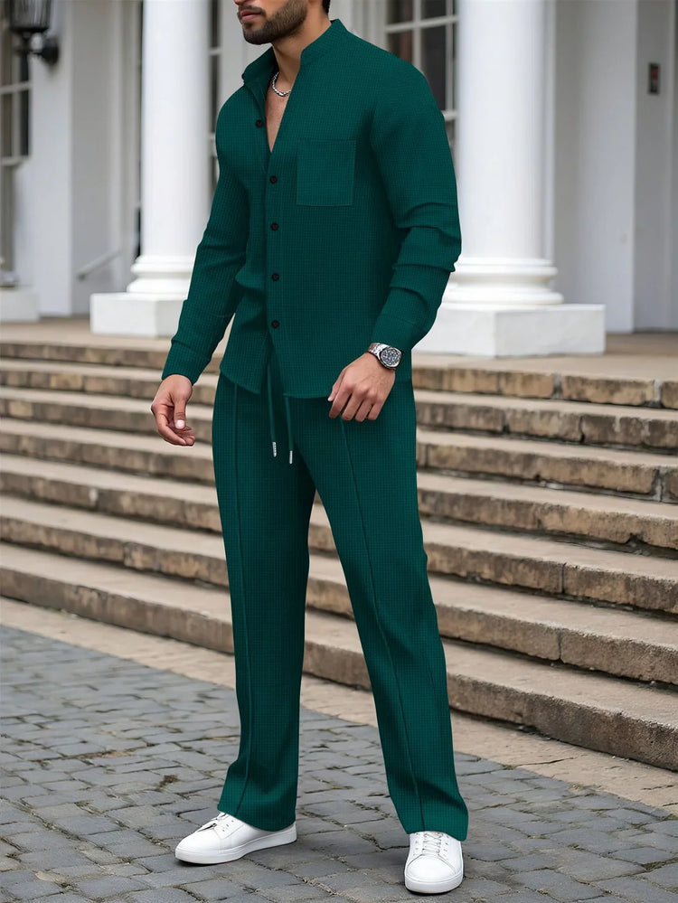 Man wearing dark green textured two-piece set with relaxed fit and white sneakers outdoors