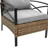 Outdoor armchair with black metal frame, woven rattan sides, and light grey cushions