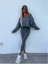 Woman wearing grey knit two-piece set with off-shoulder cropped sweater and fitted midi skirt