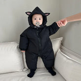 Baby in black hooded onesie with cat ear details, puffer material, relaxed fit