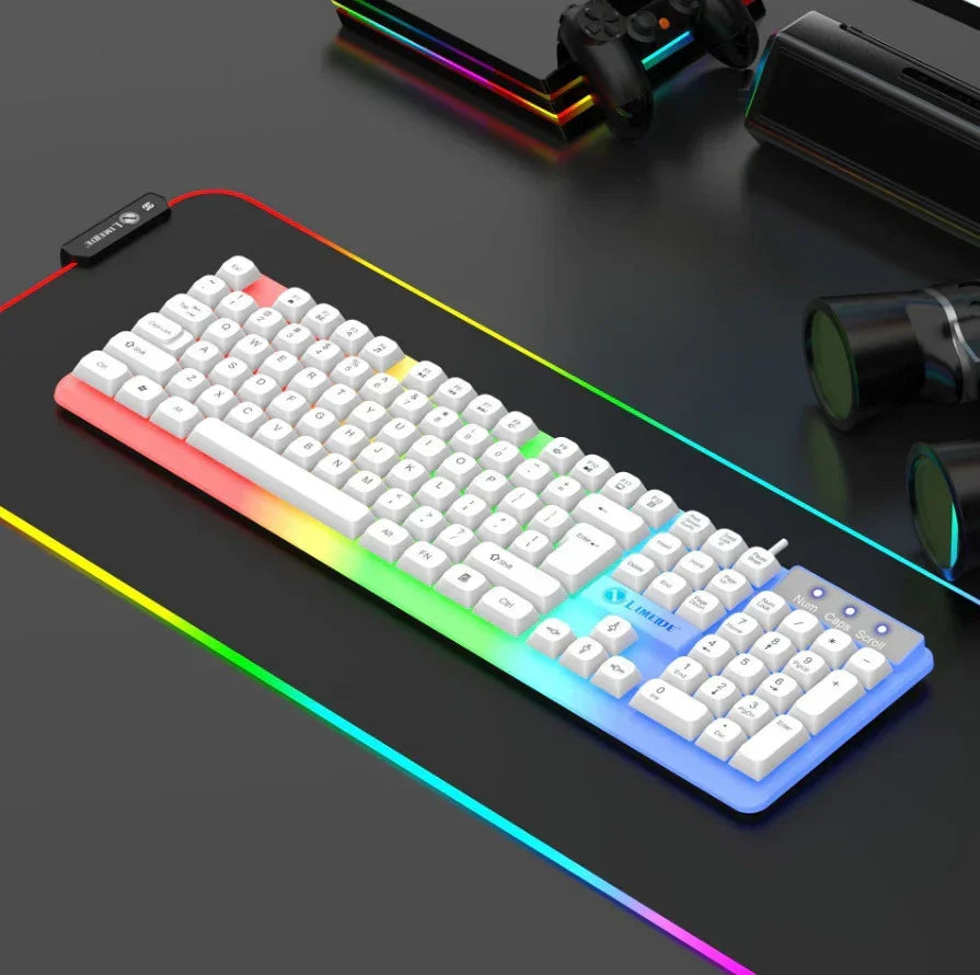 White mechanical keyboard with RGB backlighting on a black RGB gaming desk mat, tech accessories nearby.