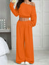 Woman wearing orange off-shoulder knit crop top and wide-leg lounge pants set
