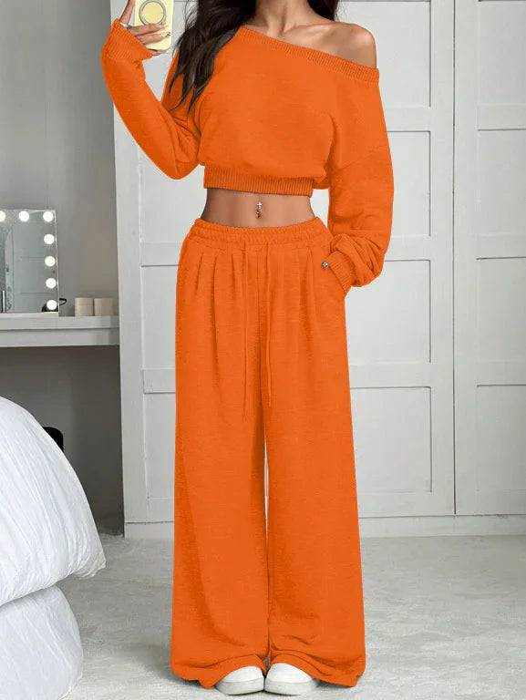Woman wearing orange off-shoulder knit crop top and wide-leg lounge pants set