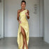 Woman in a yellow satin one-shoulder gown with high slit, fitted elegant evening wear