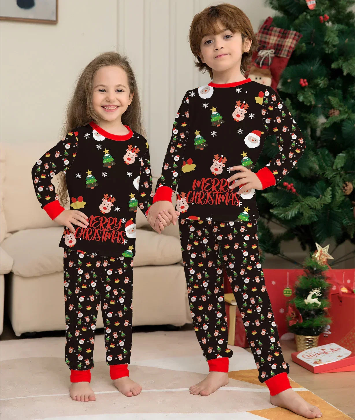Kids in matching Christmas pajamas, black with festive prints, red cuffs, relaxed fit