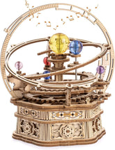 Wooden mechanical orrery model with colorful acrylic planets and intricate gears