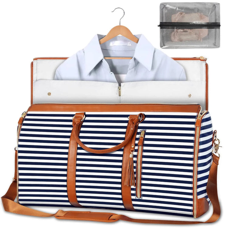 Navy and white striped weekender bag with brown leather straps, zipper closure, and detachable shoulder strap, shown with a dress shirt inside and a mesh toiletry pouch nearby.