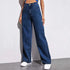 Woman wearing high-waisted wide leg dark blue denim jeans with relaxed fit