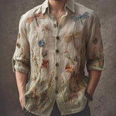 Beige linen button-up shirt with embroidered dragonflies and floral patterns, relaxed fit.
