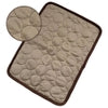 Beige quilted potholder with brown trim, circular stitched pattern, close-up detail