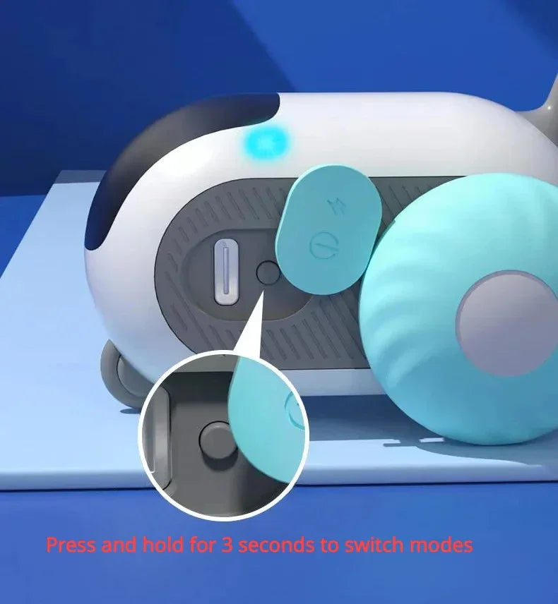 Close-up of a modern blue and white tech gadget with a round button and light indicator, shown on a blue surface.