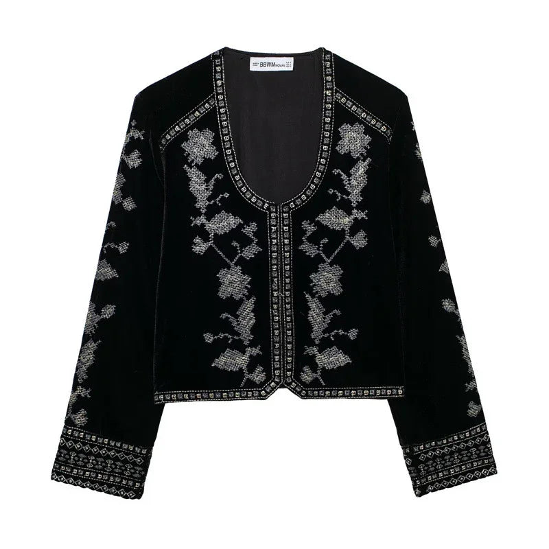 Black velvet jacket with silver floral embroidery, long sleeves, and relaxed fit.