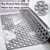 Gray rubber shower mat with large round holes for fast drainage on bathroom floor