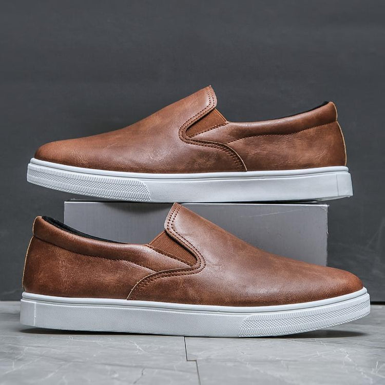Men’s brown leather slip-on sneakers with white rubber soles, casual streetwear style