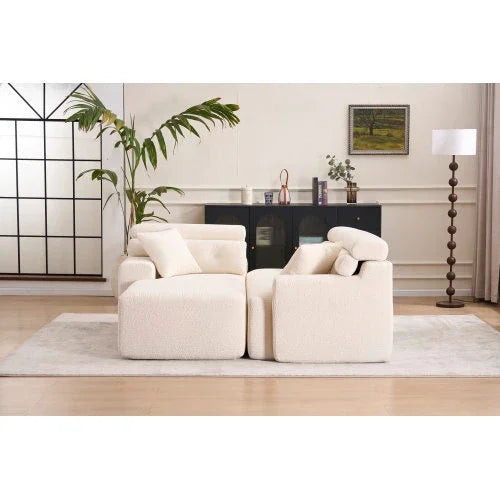 Modern cream-colored boucle sofas with plush cushions and relaxed fit in a stylish living room