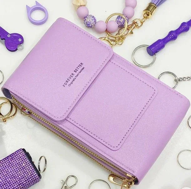 Pastel purple faux leather wallet with zipper, surrounded by matching purple accessories.