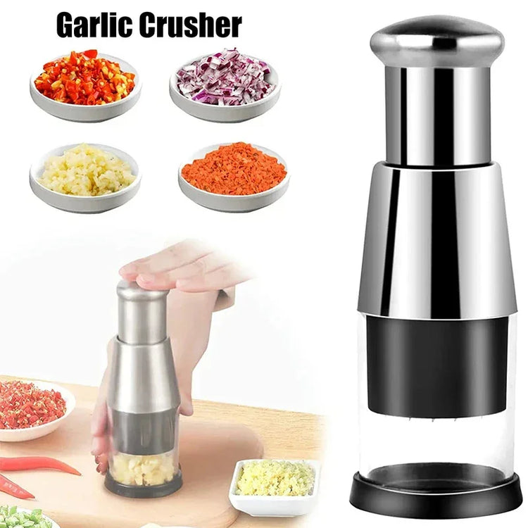 Stainless steel garlic crusher with clear container, chopping mixed vegetables on kitchen counter.