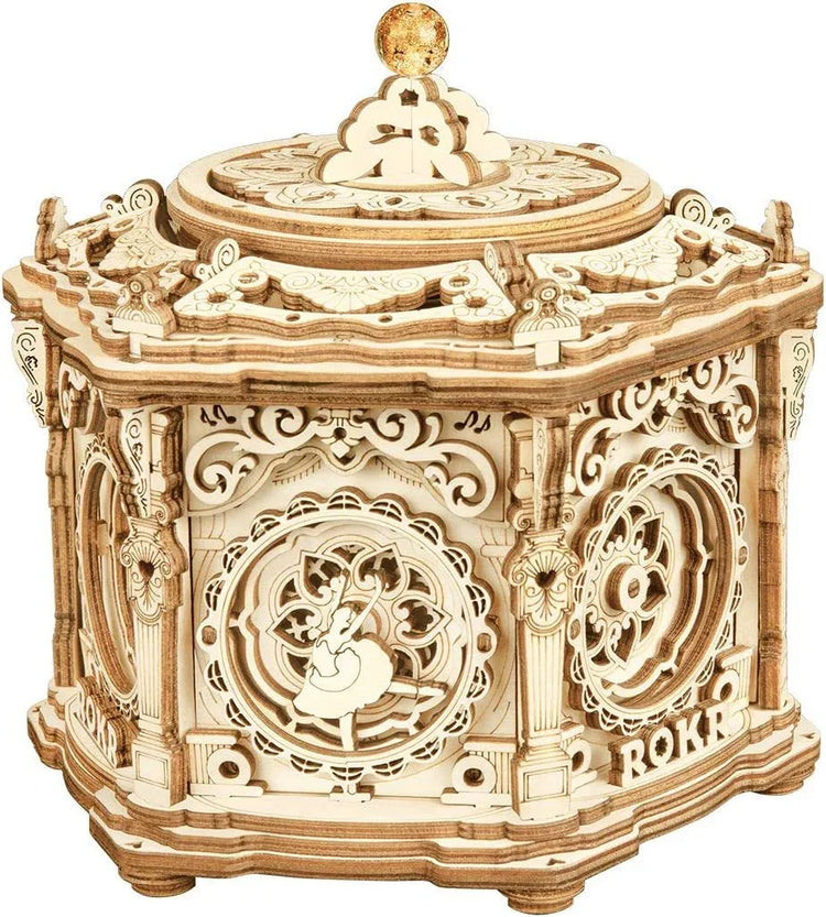 Intricately detailed wooden music box with ornate design and ballerina figure, hexagonal shape
