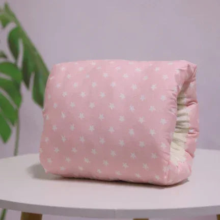 Soft pink fleece blanket with white star pattern, plush and cozy, folded on a table