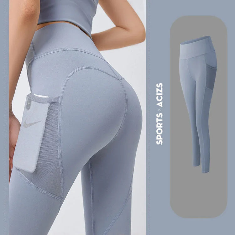 High-waisted light gray athletic leggings with side pocket, fitted stretch material.